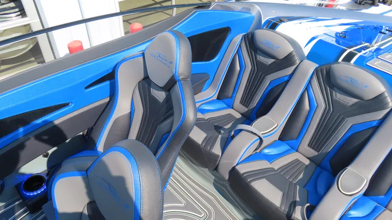 Slide: The Image of 2023 MTI 390X boat interior with blue and gray seats. - 23