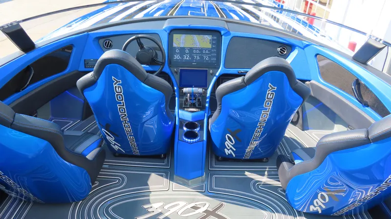 Slide: The Image of 2023 MTI 390X boat interior with blue seats and advanced dashboard technology. - 26