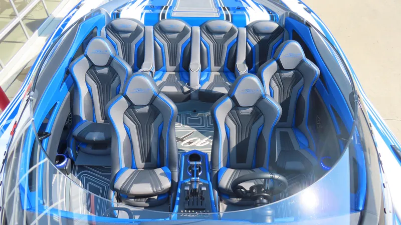 Slide: The Image of 2023 MTI 390X boat interior with blue and gray seating, modern design. - 9