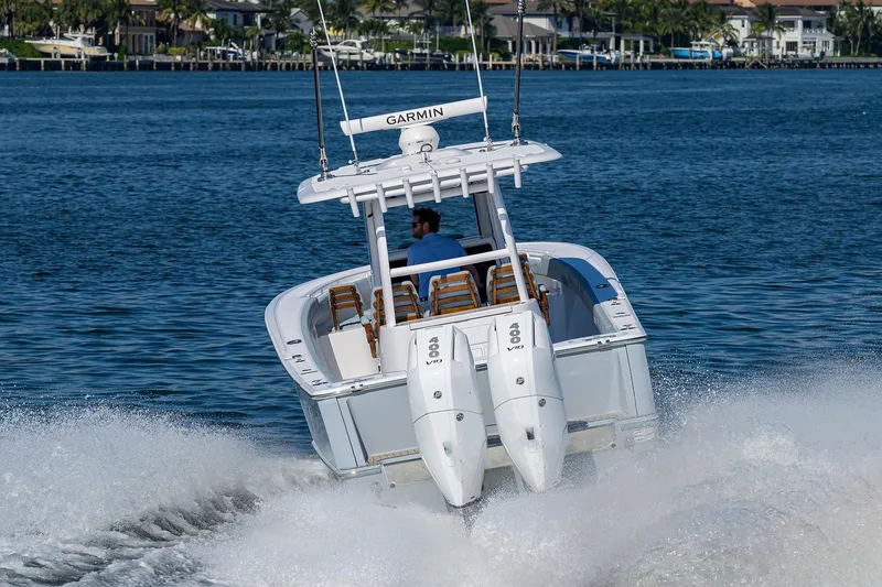 Slide: The Image of 2026 Phenom 34 Center Console boat cruising on water with twin engines. - 11