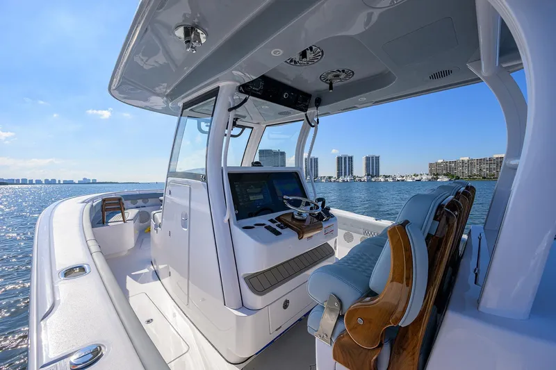 Slide: The Image of 2026 Phenom 34 Center Console boat on water, modern design, city skyline in background. - 12