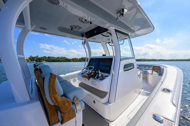 Slide: The Image of 2026 Phenom 34 Center Console boat interior with advanced navigation system on a sunny day. - 13