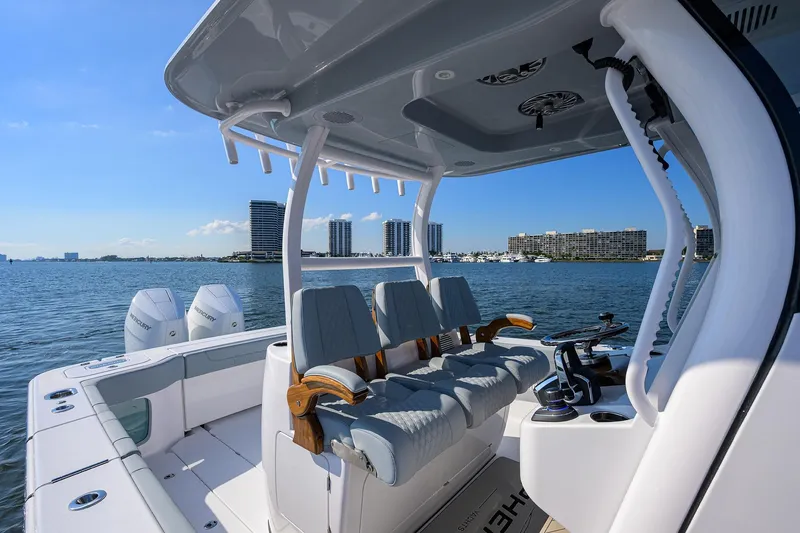 Slide: The Image of 2026 Phenom 34 Center Console boat on water, modern seating, city skyline in background. - 15