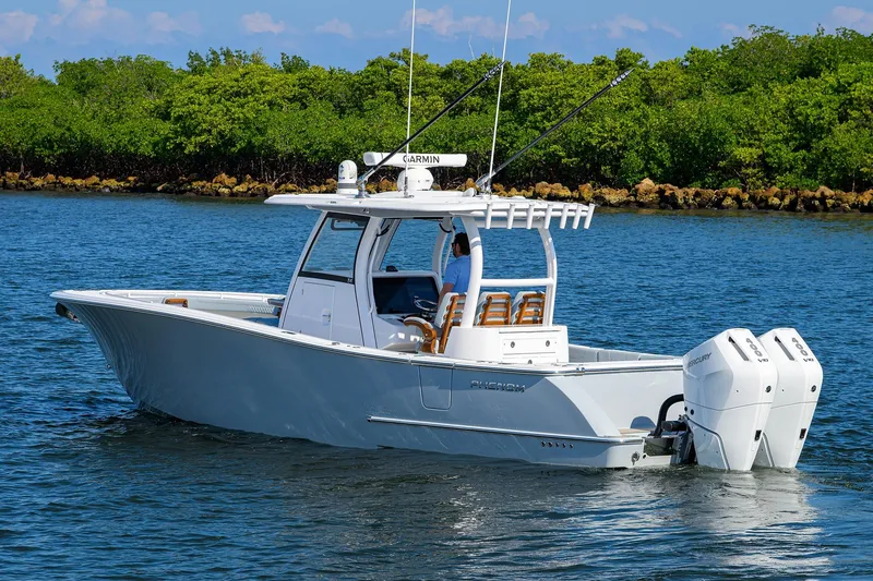 Slide: The Image of 2026 Phenom 34 Center Console boat on water, featuring dual outboard engines. - 2