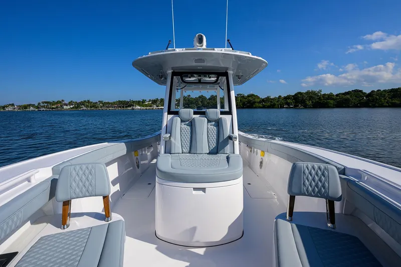 Slide: The Image of 2026 Phenom 34 Center Console boat on calm water, featuring luxurious seating and sleek design. - 20