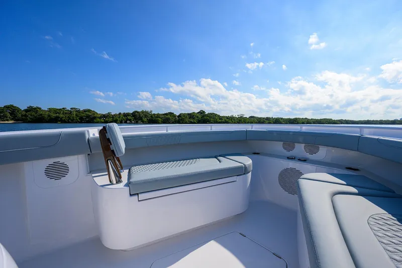 Slide: The Image of 2026 Phenom 34 Center Console boat interior with cushioned seating and scenic water view. - 24