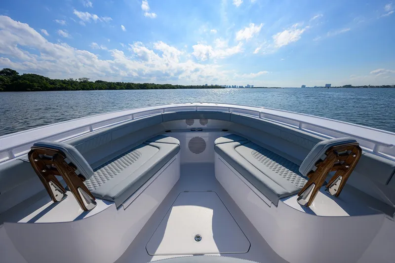 Slide: The Image of 2026 Phenom 34 Center Console boat with spacious seating, on a serene water backdrop. - 25