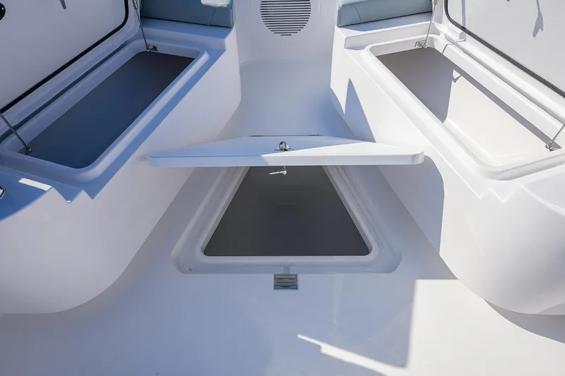 Slide: The Image of 2026 Phenom 34 Center Console boat storage compartments open on deck. - 27