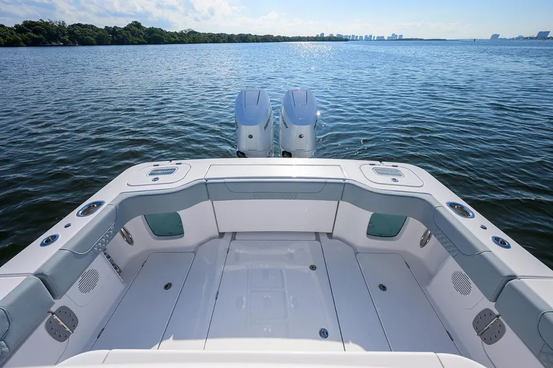 Slide: The Image of 2026 Phenom 34 Center Console boat on calm water, featuring dual engines and spacious deck. - 32