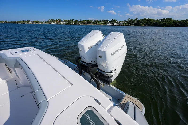 Slide: The Image of 2026 Phenom 34 Center Console boat with dual Mercury outboard engines on a calm lake. - 38