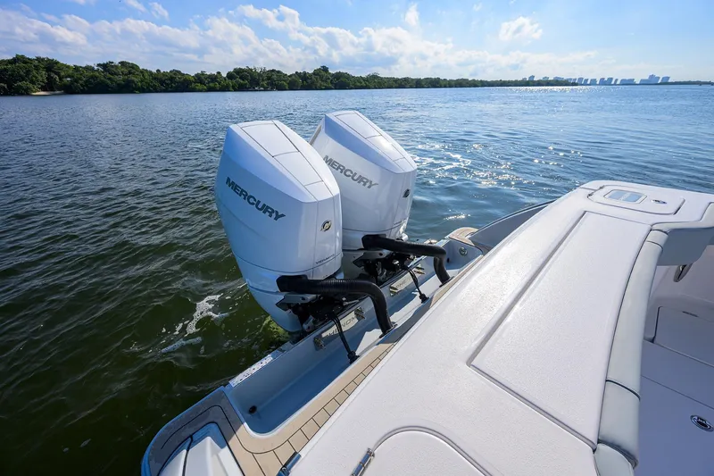 Slide: The Image of 2026 Phenom 34 Center Console boat with dual Mercury outboard engines on a sunny day. - 39