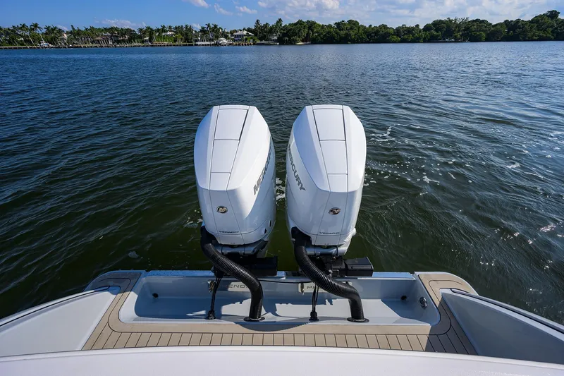 Slide: The Image of 2026 Phenom 34 Center Console with dual Mercury outboard engines on a calm lake. - 40