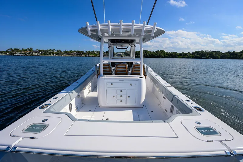 Slide: The Image of 2026 Phenom 34 Center Console boat on calm water, clear sky background. - 44