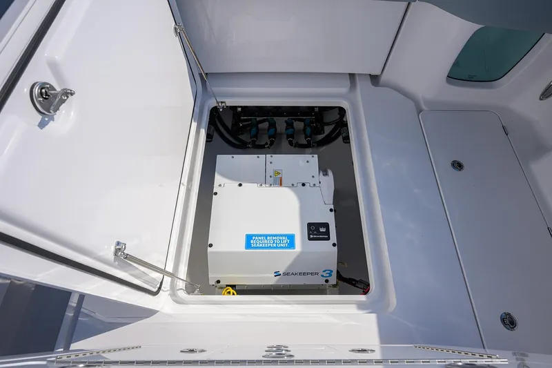Slide: The Image of 2026 Phenom 34 Center Console with Seakeeper 3 stabilizer in open compartment. - 49