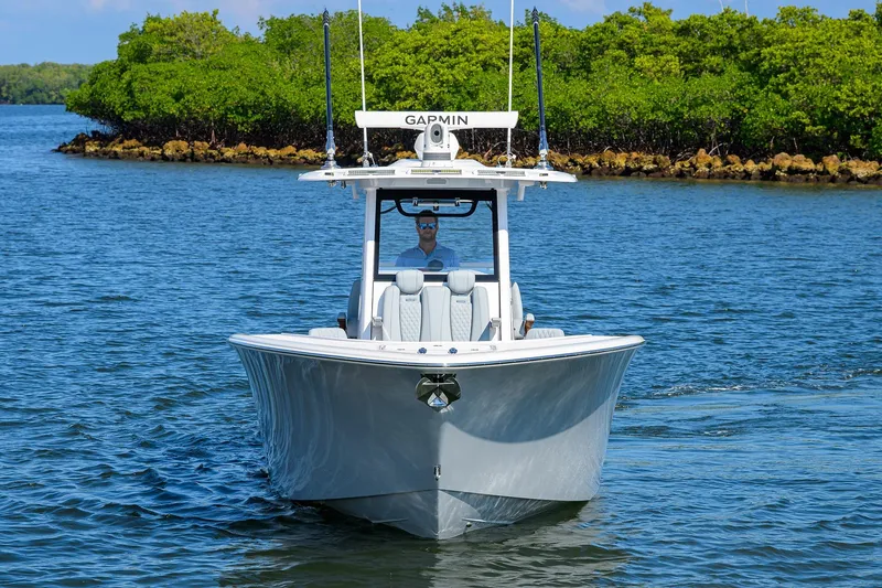 Slide: The Image of 2026 Phenom 34 Center Console boat cruising on a serene waterway. - 8