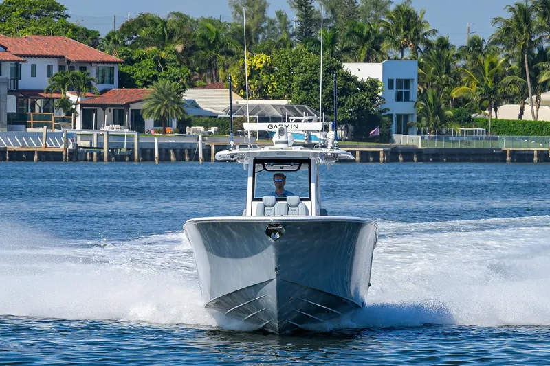 Slide: The Image of 2026 Phenom 34 Center Console boat cruising on a sunny waterfront. - 9