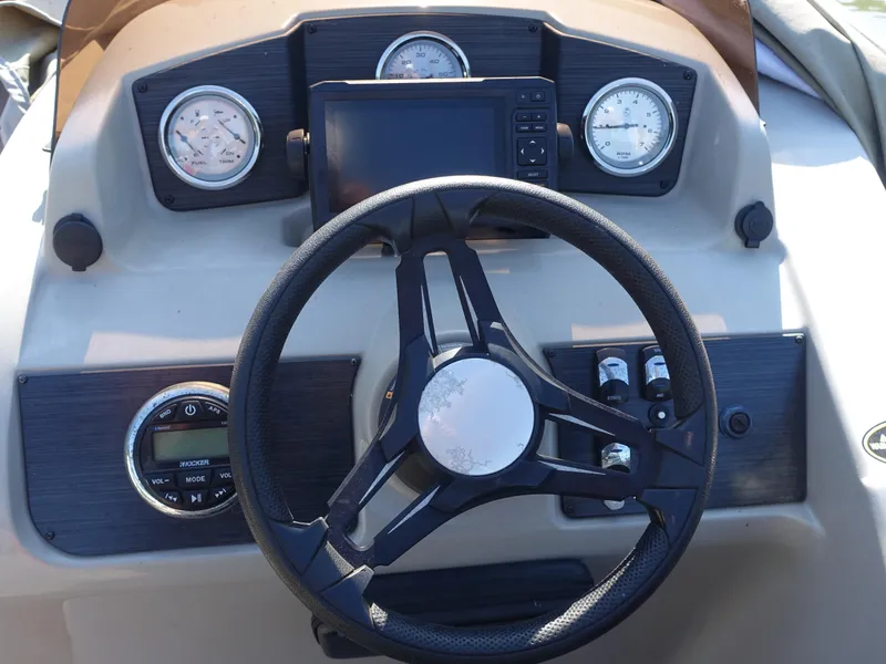 Slide: The Image of Steering console of 2018 Cypress Cay Seabreeze 212 boat with gauges and controls. - 3