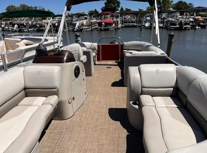 Slide: The Image of 2018 Cypress Cay Seabreeze 212 pontoon boat with spacious seating at a marina. - 6