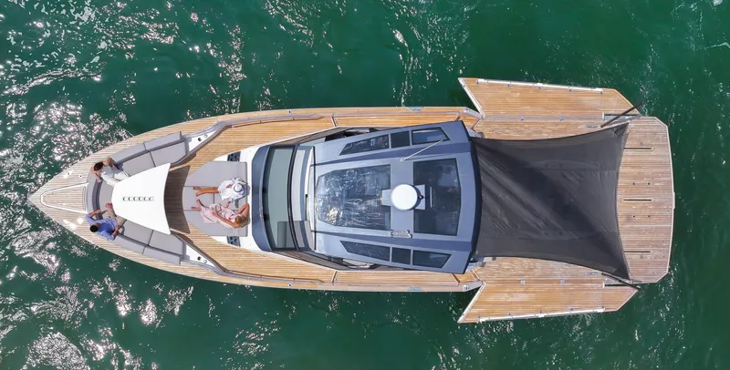 Slide: The Image of Aerial view of 2023 OKEAN 57 yacht with people relaxing on deck. - 1