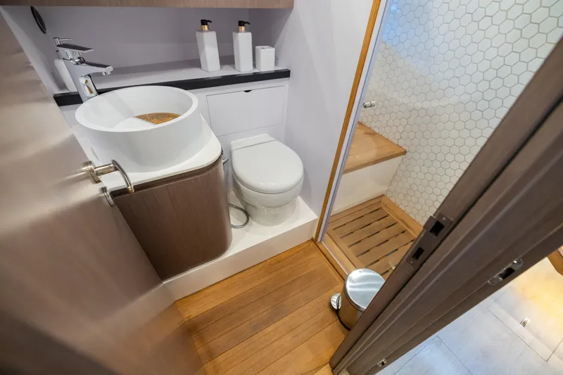 Slide: The Image of Modern bathroom on 2023 OKEAN 57 yacht with wooden flooring and sleek fixtures. - 11