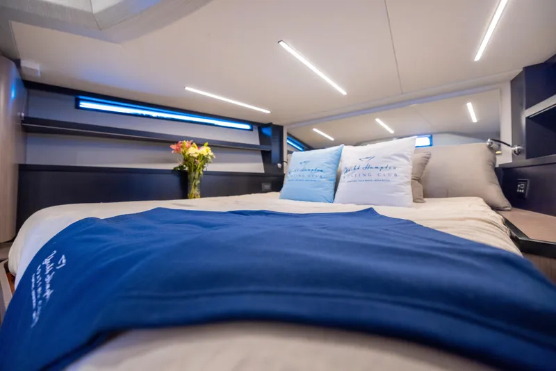 Slide: The Image of Luxurious interior of 2023 OKEAN 57 yacht with elegant bedding and ambient lighting. - 12