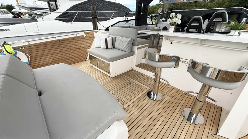 Slide: The Image of Luxurious 2023 OKEAN 57 yacht interior with sleek seating and modern design. - 20