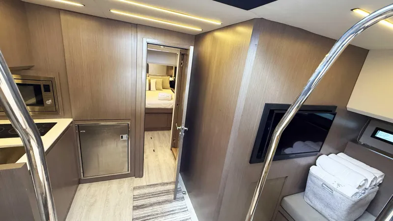 Slide: The Image of Luxurious interior of 2023 OKEAN 57 yacht featuring modern kitchen and cozy bedroom. - 23