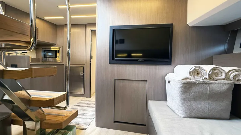 Slide: The Image of Modern interior of 2023 OKEAN 57 yacht with TV, stairs, and rolled towels. - 25