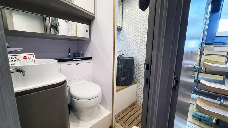 Slide: The Image of Modern bathroom on 2023 OKEAN 57 yacht with sleek fixtures and hexagonal tile design. - 27