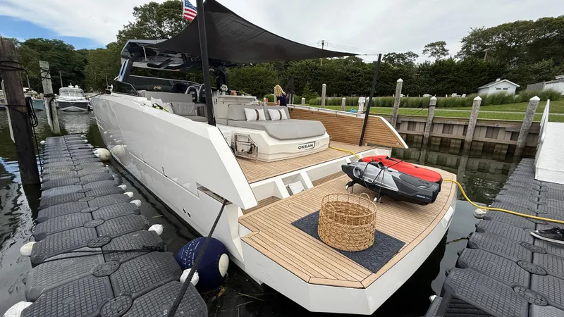 Slide: The Image of Luxury 2023 OKEAN 57 yacht docked, featuring sleek design and spacious deck. - 28