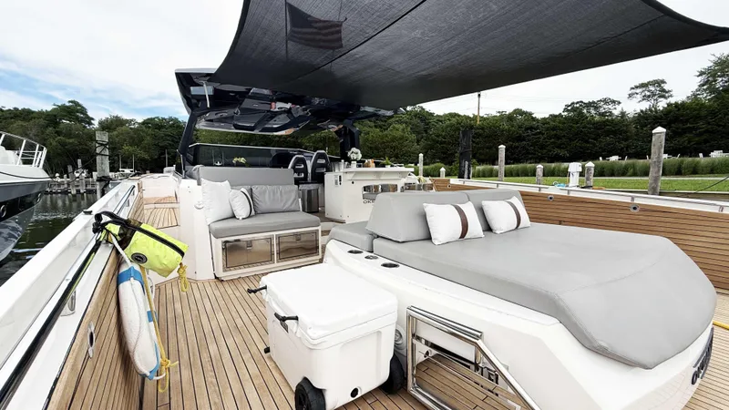 Slide: The Image of Luxurious 2023 OKEAN 57 yacht deck with seating, canopy, and modern amenities. - 29