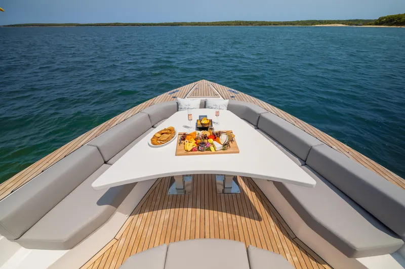 Slide: The Image of Luxurious 2023 OKEAN 57 yacht deck with elegant dining setup and ocean view. - 4