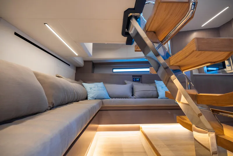 Slide: The Image of Luxurious interior of 2023 OKEAN 57 yacht with modern staircase and comfortable seating. - 8