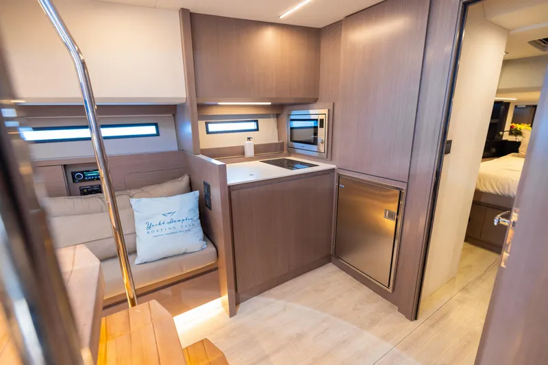 Slide: The Image of Luxurious interior of 2023 OKEAN 57 yacht featuring modern kitchen and cozy seating area. - 9
