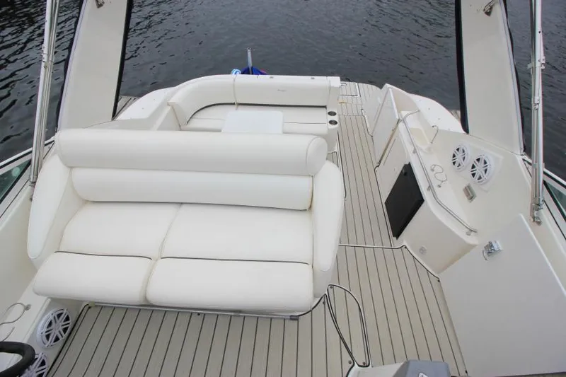 Slide: The Image of 2006 Cruisers Yachts 320 Express interior with white seating and deck view. - 11