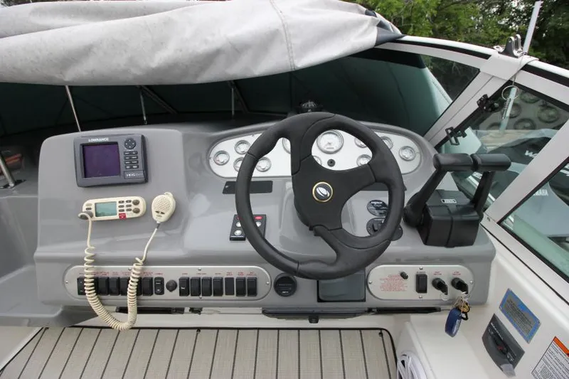 Slide: The Image of 2006 Cruisers Yachts 320 Express helm with steering wheel, controls, and navigation equipment. - 13