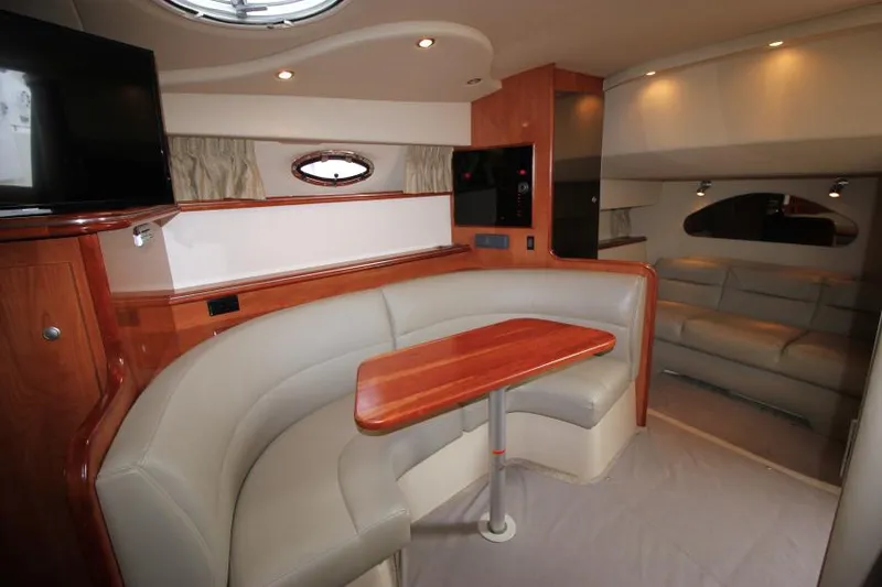 Slide: The Image of 2006 Cruisers Yachts 320 Express interior with dining area and seating. - 16