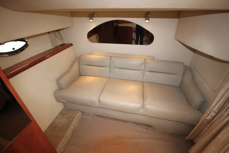 Slide: The Image of 2006 Cruisers Yachts 320 Express interior with beige leather sofa and modern lighting. - 17