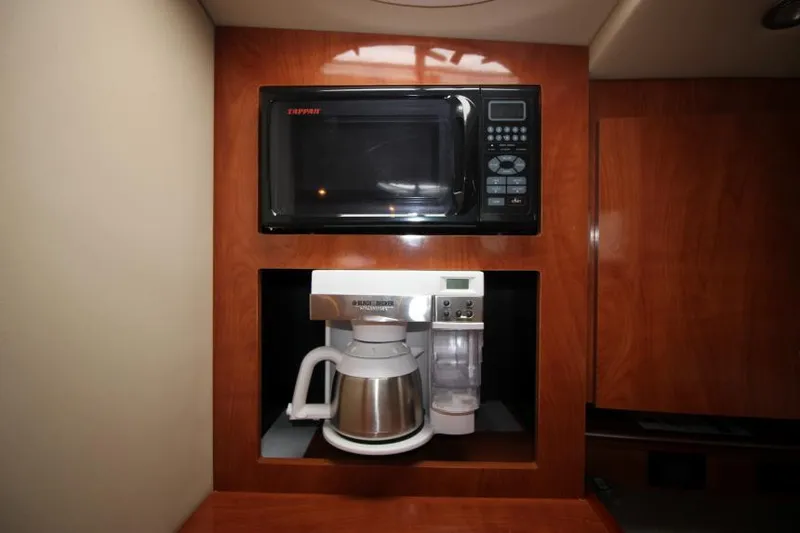 Slide: The Image of 2006 Cruisers Yachts 320 Express galley with microwave and coffee maker. - 22