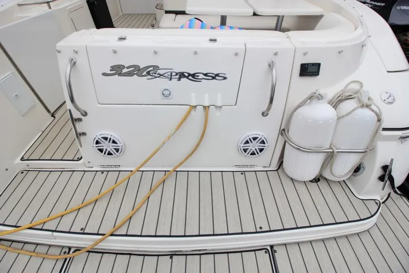 Slide: The Image of 2006 Cruisers Yachts 320 Express boat deck with storage and safety equipment. - 3