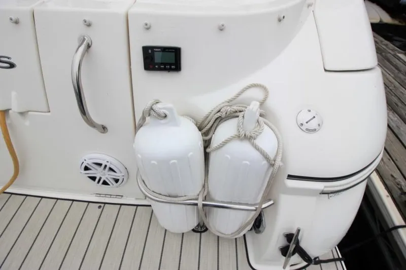 Slide: The Image of 2006 Cruisers Yachts 320 Express boat stern with fenders and deck details. - 4