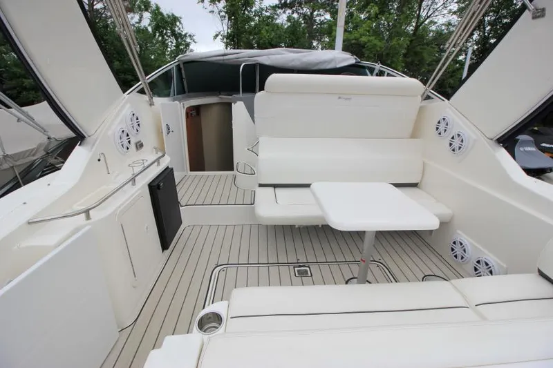 Slide: The Image of 2006 Cruisers Yachts 320 Express interior with white seating and table, featuring modern design. - 6