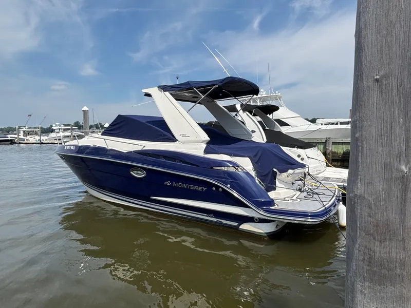 The Image of 2013 Monterey 280 SCR boat docked at marina, blue and white exterior. - 0