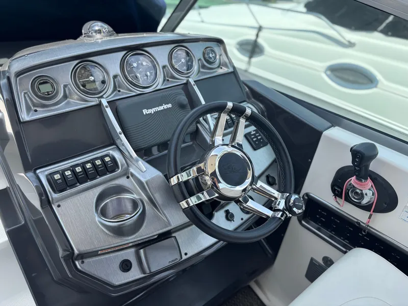 Slide: The Image of Steering console of a 2013 Monterey 280 SCR boat with Raymarine equipment. - 10