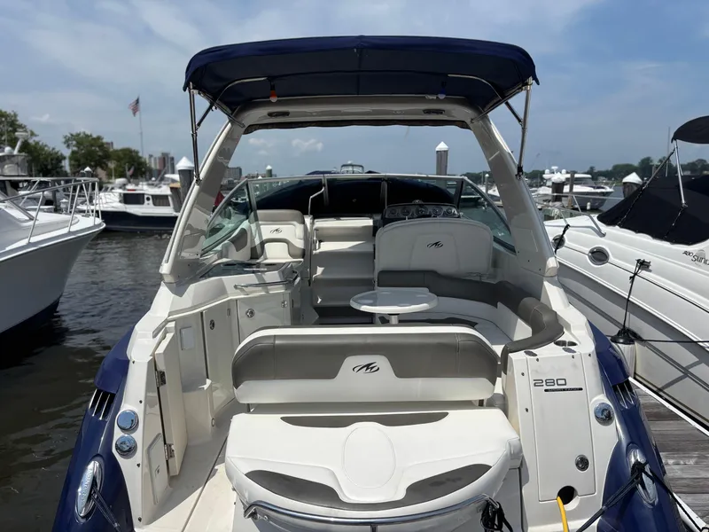 Slide: The Image of 2013 Monterey 280 SCR boat docked, featuring spacious seating and sleek design. - 11