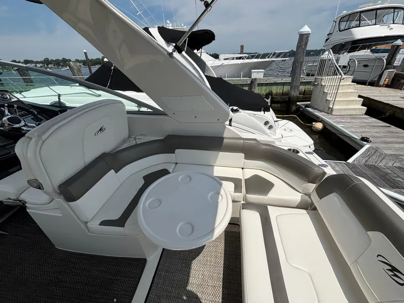Slide: The Image of 2013 Monterey 280 SCR boat interior with seating and table, docked at marina. - 12