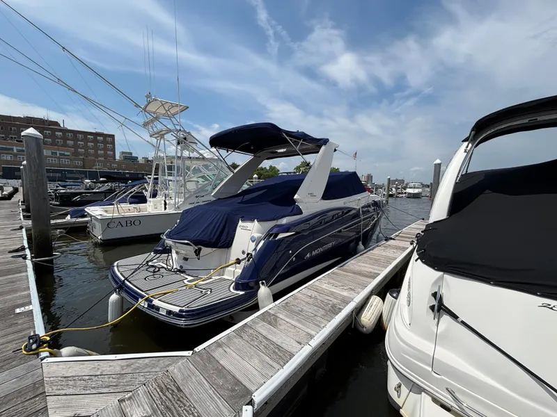 Slide: The Image of 2013 Monterey 280 SCR boat docked at marina under clear sky. - 2