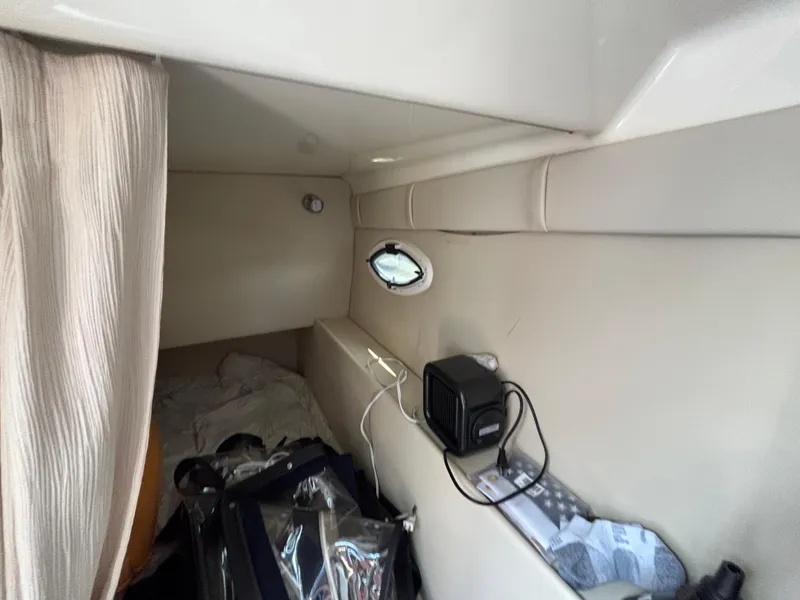 Slide: The Image of Interior cabin of 2013 Monterey 280 SCR boat with bed and small window. - 22