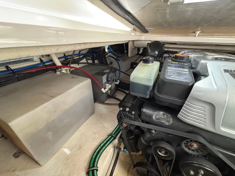 Slide: The Image of Engine compartment of a 2013 Monterey 280 SCR boat, showing mechanical components and wiring. - 25