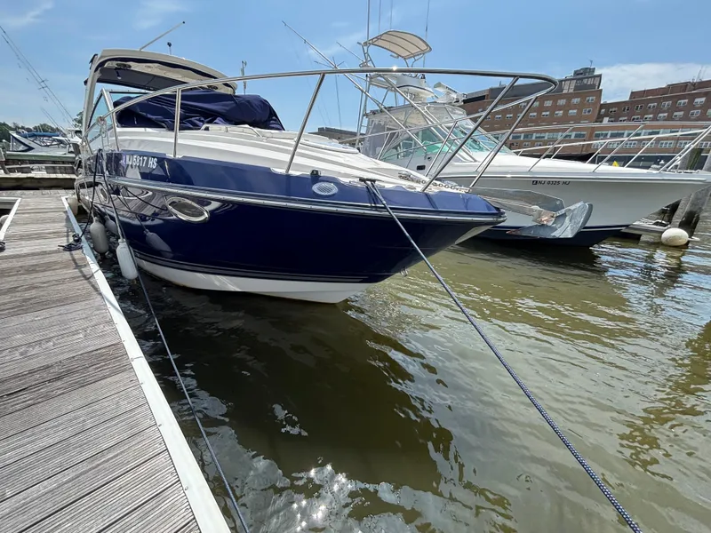 Slide: The Image of 2013 Monterey 280 SCR boat docked at marina, blue and white exterior. - 4
